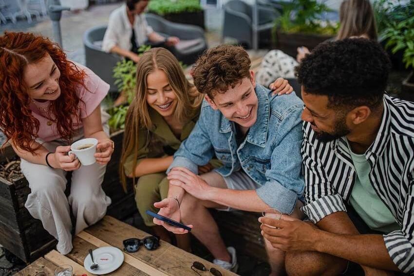 group of friends sitting next to each other having a good conversation