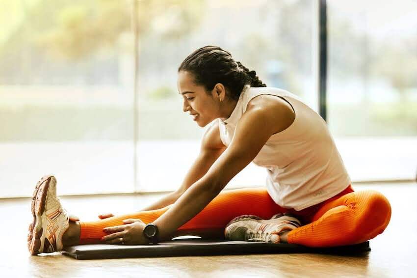 smiling woman doing yoga