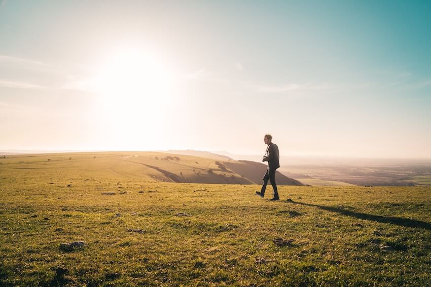 man walking outside on a sunny day