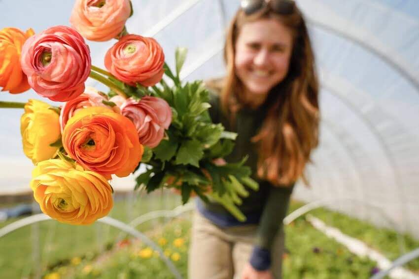 smiling woman holding a bouquet of flowers