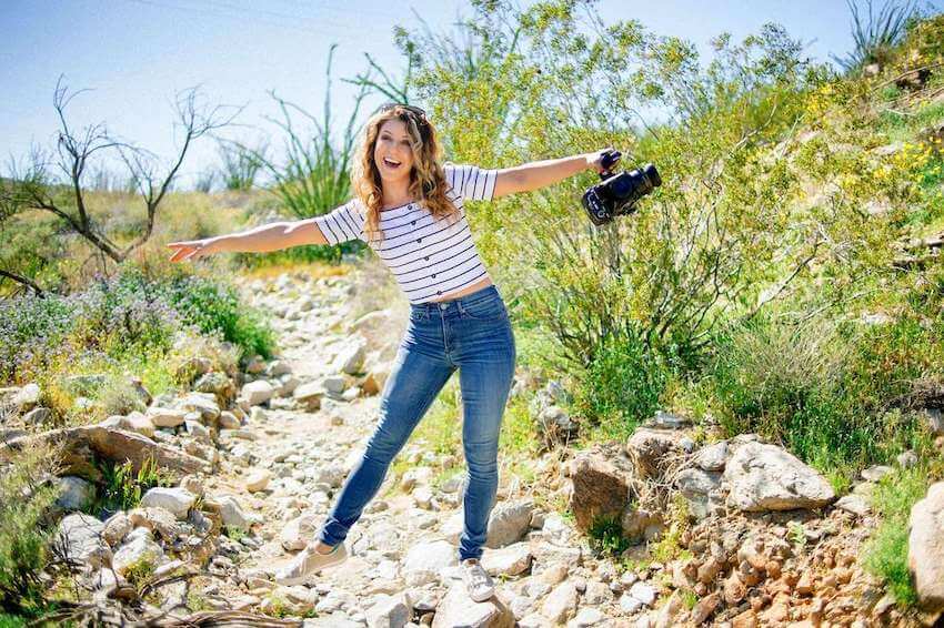 happy woman holding a camera
