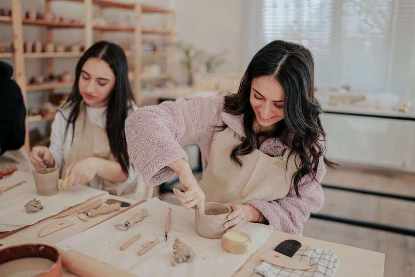 happy woman making pottery