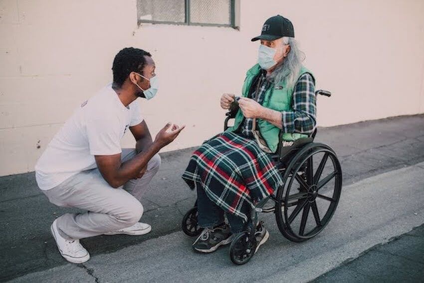 man assisting another