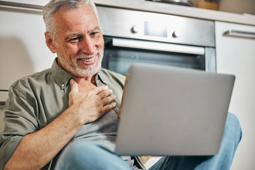 man feeling touched by an expression of gratitude on his laptop screen