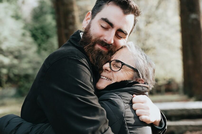 man hugging his mom in gratitude
