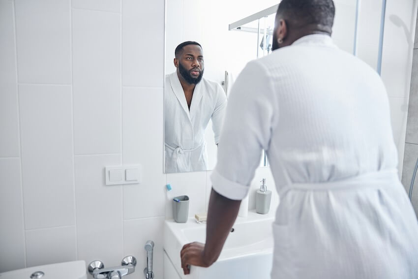man looking at himself in the mirror