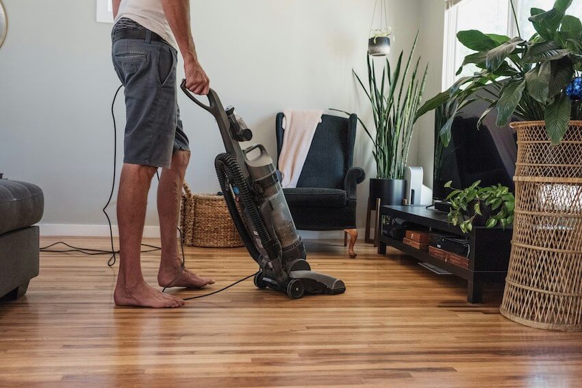 man vacuuming his living room