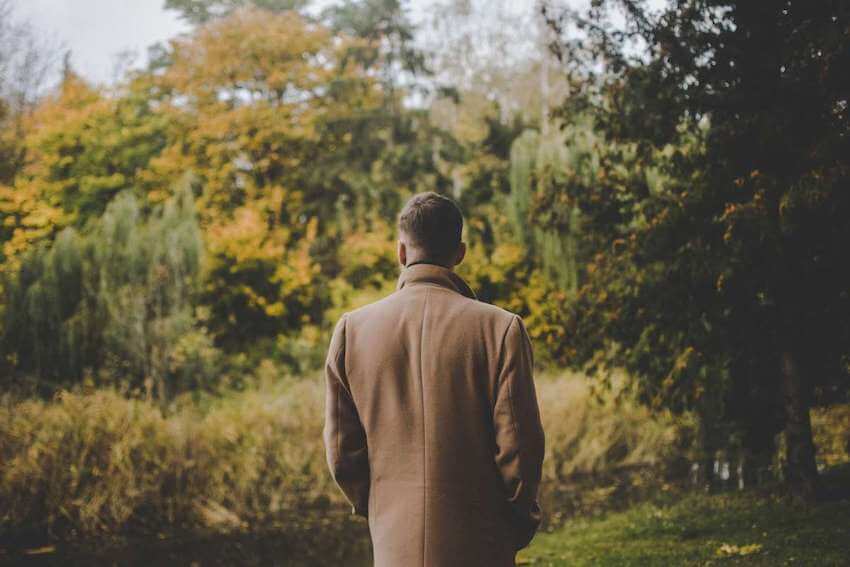 man walking in the woods