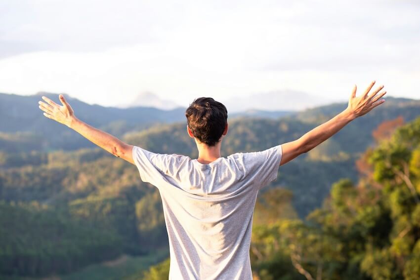 man with his arms wide open in an expression of gratitude