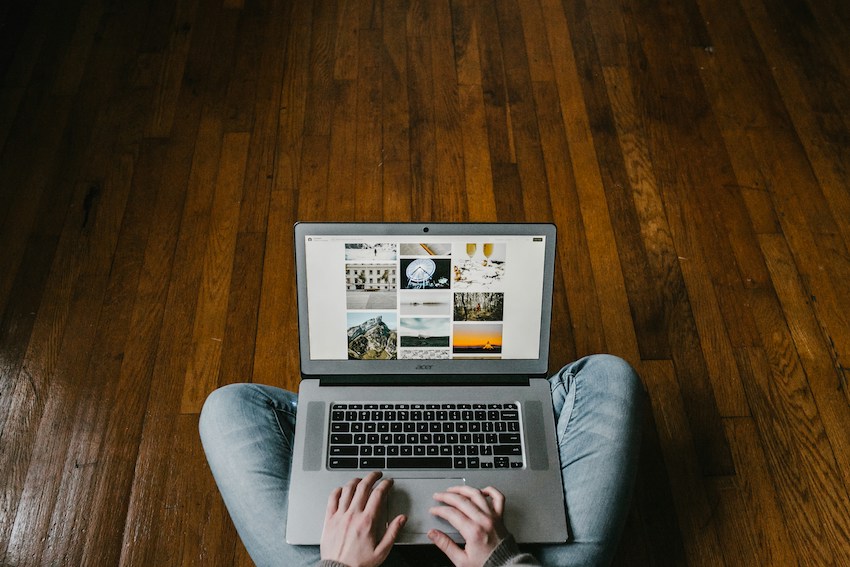 person sitting crosslegged surfing online