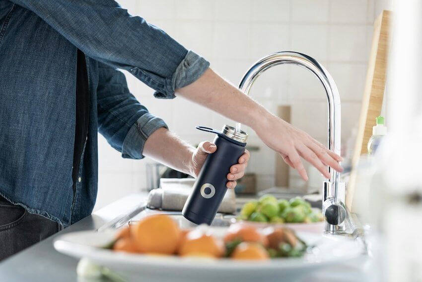 running water filling a bottle