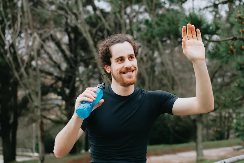 smiling man giving a friendly wave
