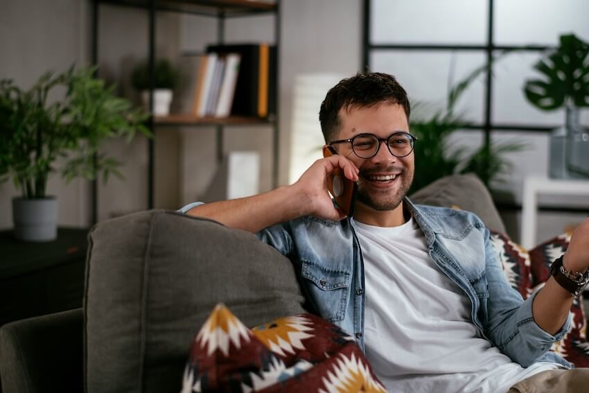 smiling man talking on the phone