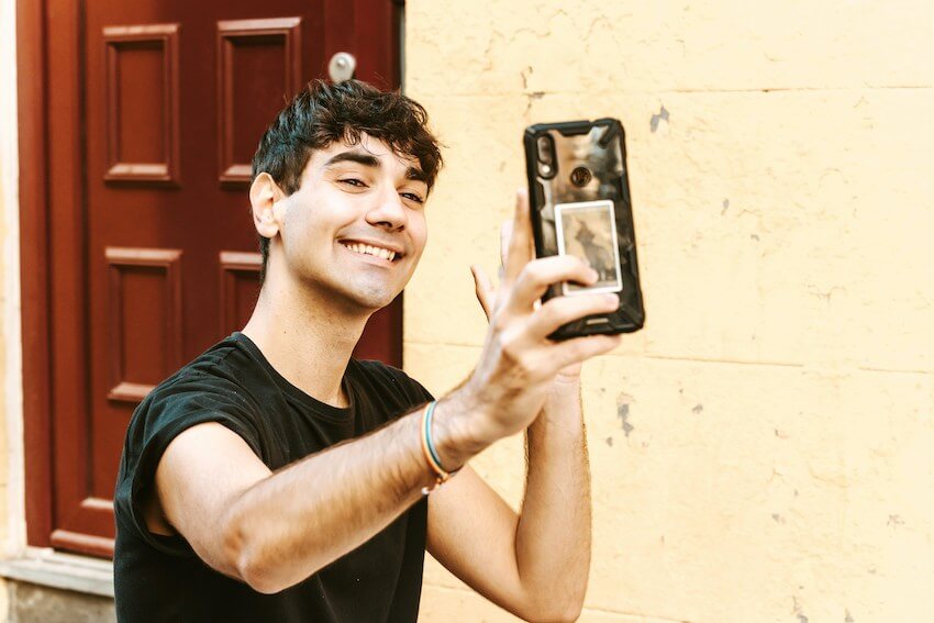 smiling man video chatting with his friend