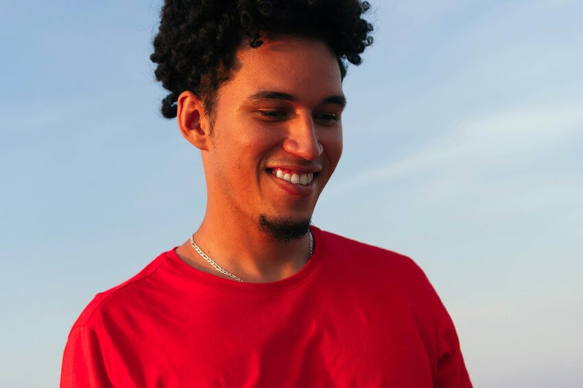 smiling man wearing a red shirt