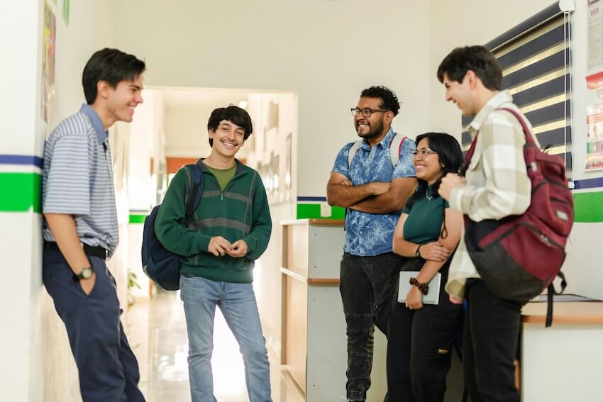 smiling students standing in a circle