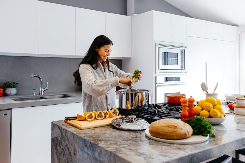 smiling woman cooking a meal