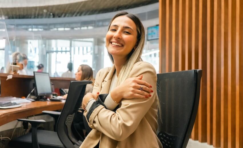 smiling woman giving herself a hug