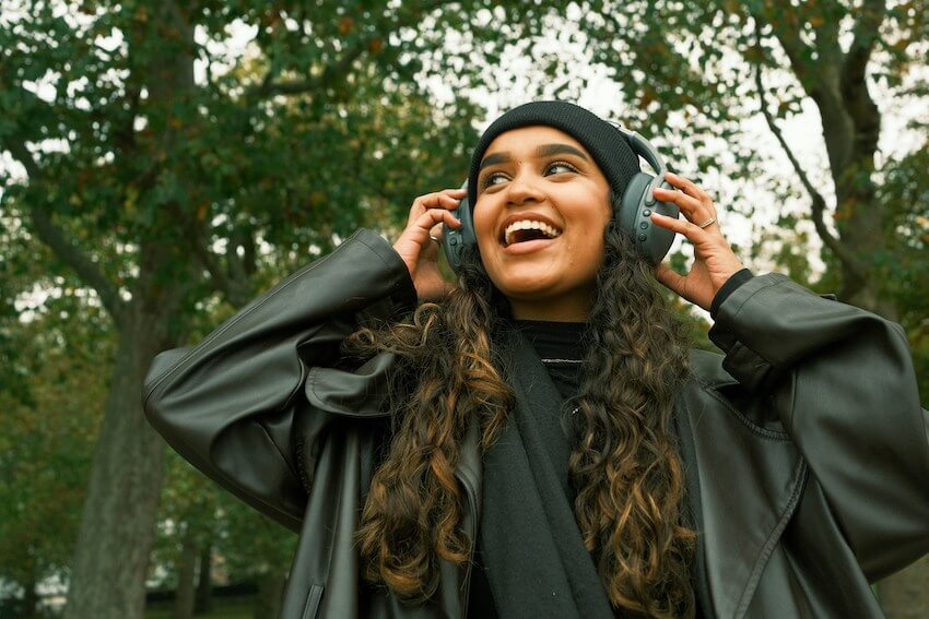 smiling woman listening to music