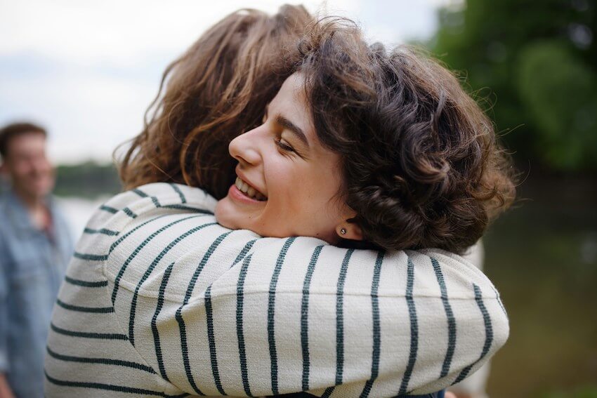 two friends sharing a hug
