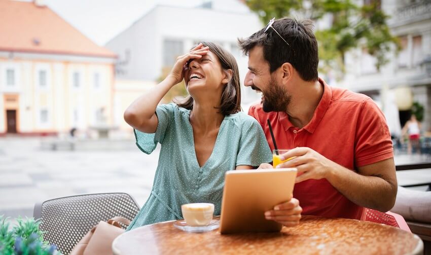 two people laughing about a funny story