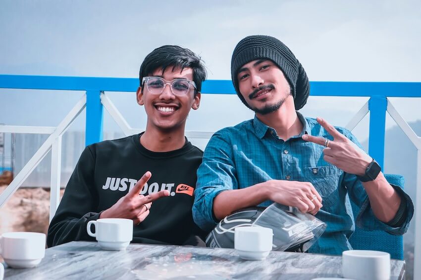 two smiling brothers spending time outside