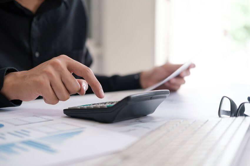 woman budgeting with a calculator