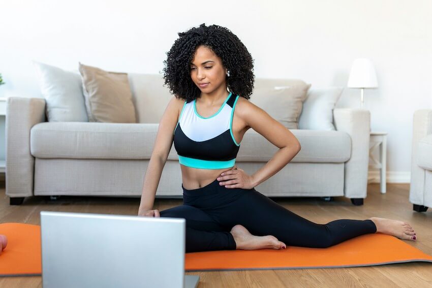 woman doing yoga on an orange yoga mat