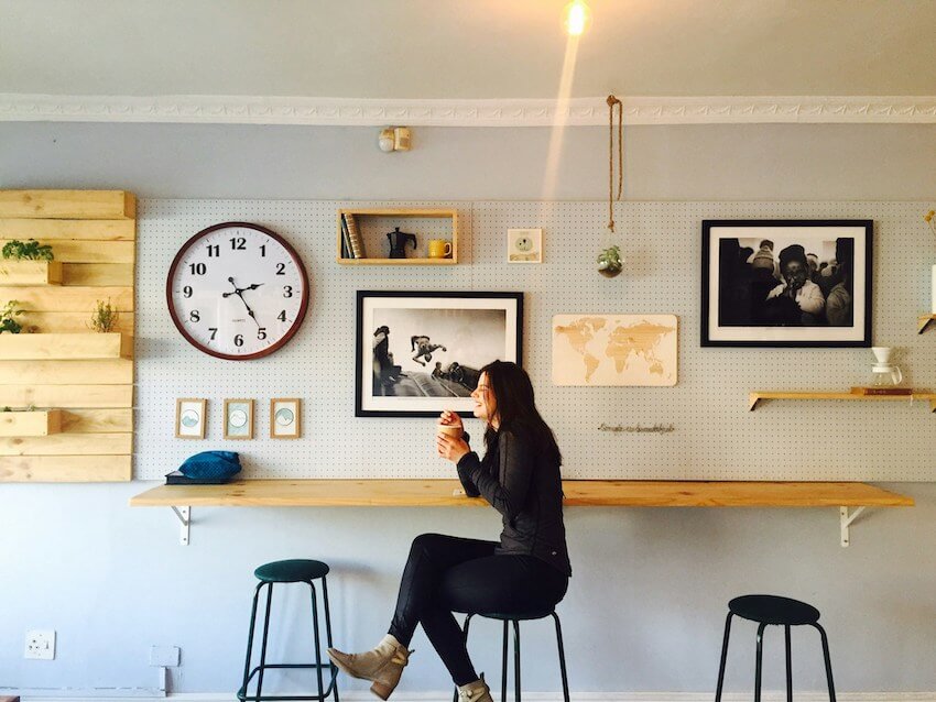 woman enjoying a cup of coffee at a local coffee shop