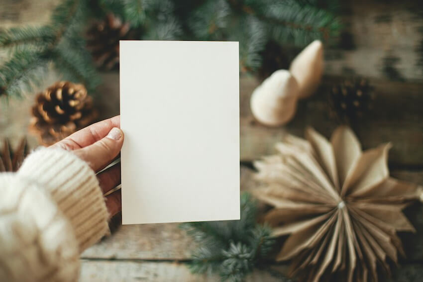 woman holding a blank holiday card