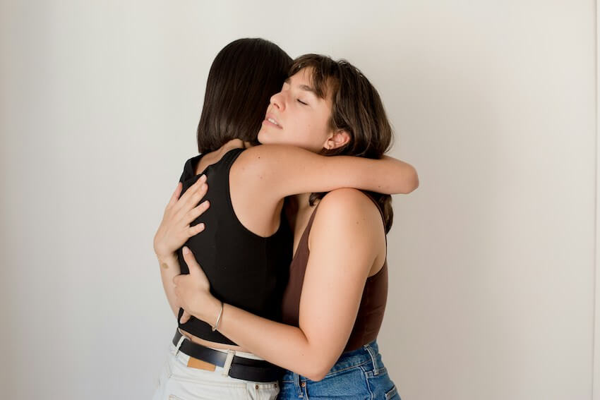 woman hugging her sad friend