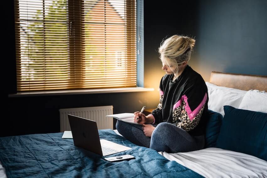 woman journaling in bed