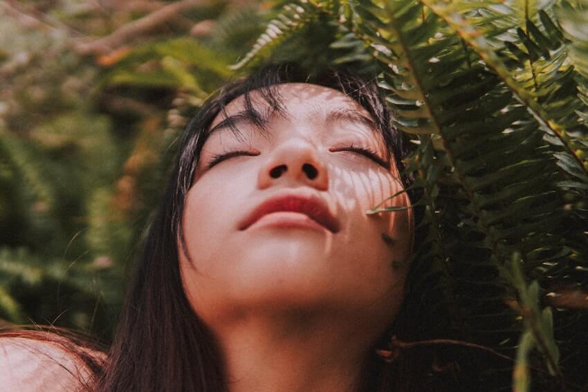 woman laying on the ground daydreaming