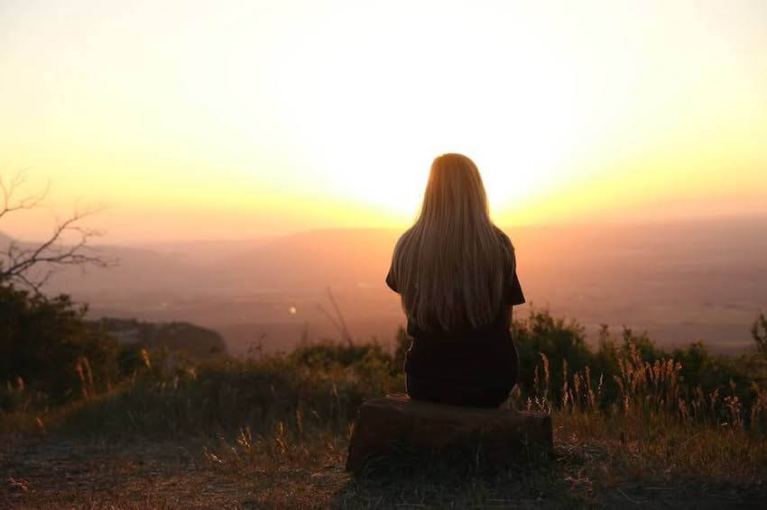 woman looking at the sunrise