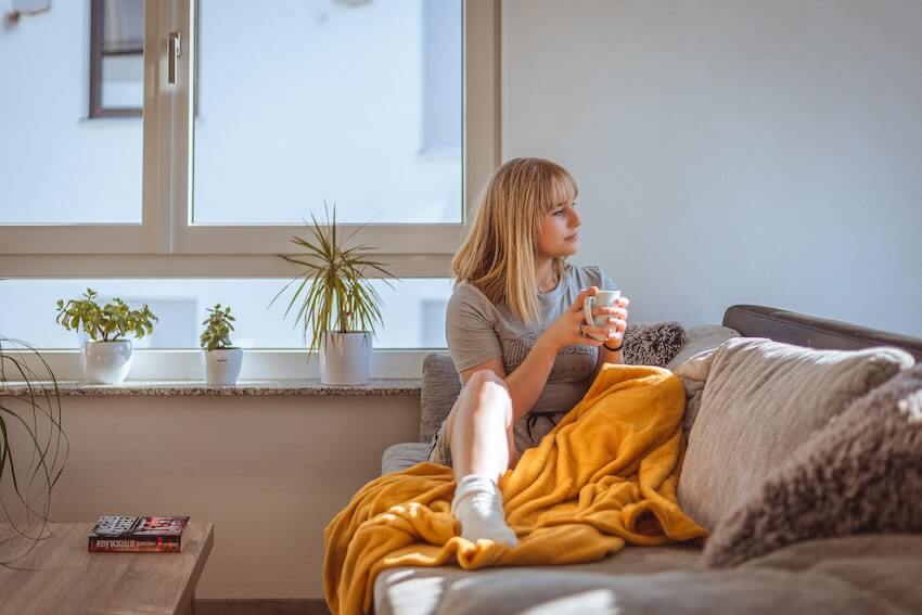 woman sitting in the living room observing her surroundings