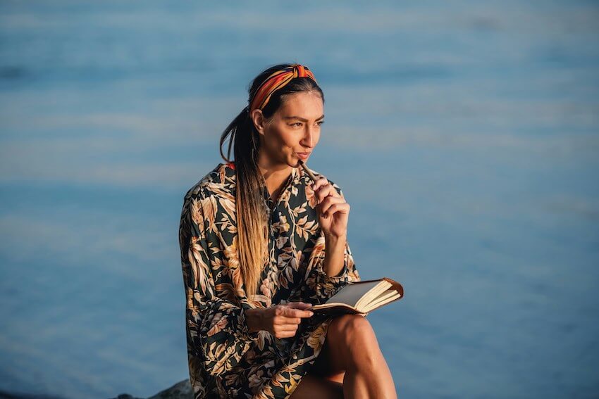 woman thinking about what to write in her gratitude journal