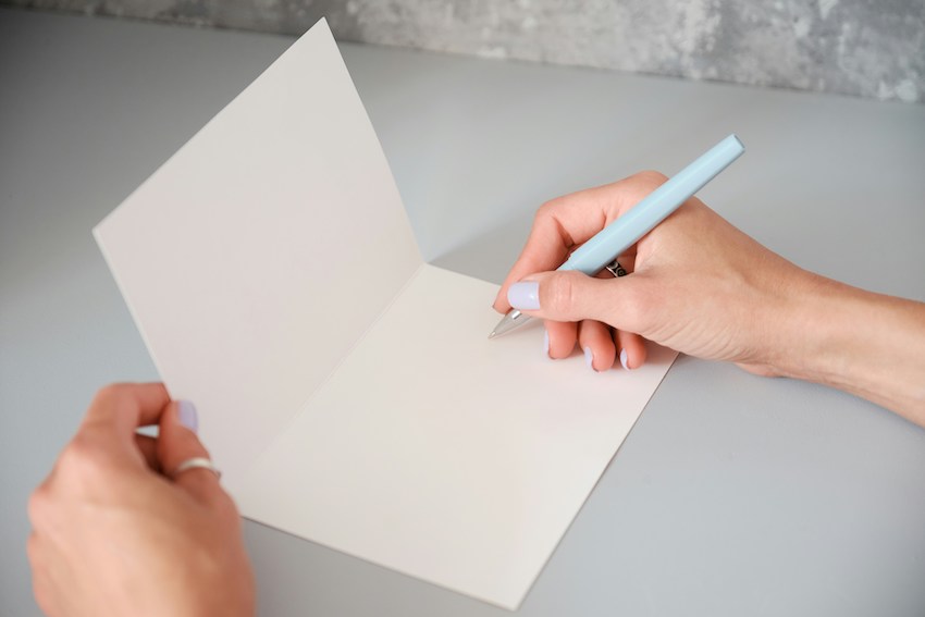 woman writing in a card