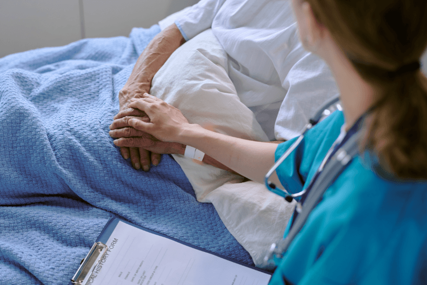 female anesthesiologist holding a patient's hands before surgery
