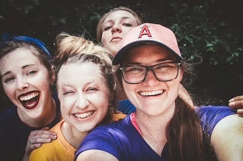 4 smiling women taking a selfie
