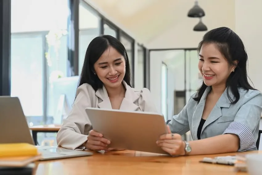 an older woman mentoring a younger woman