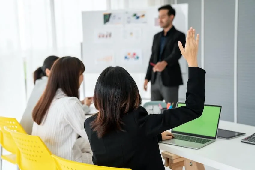 woman with her arm raised during class