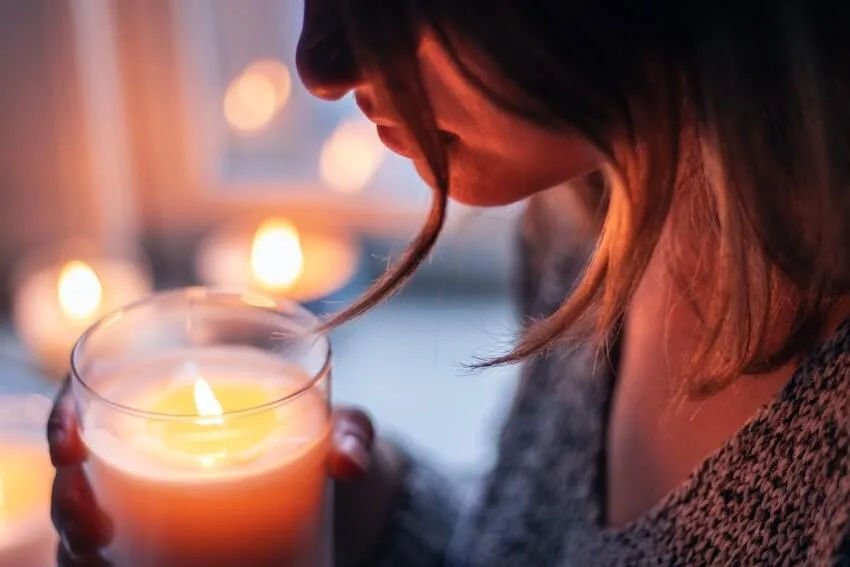 a woman holding a candle