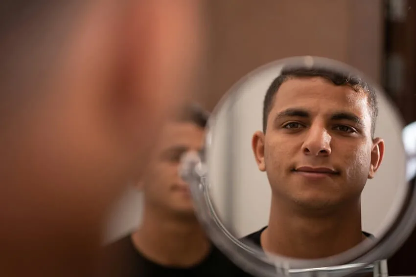 man looking at himself in the mirror