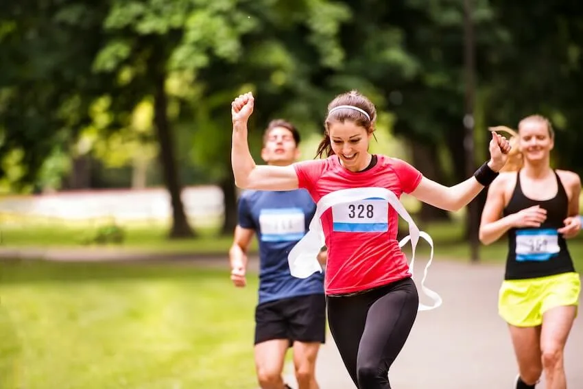 female runner crossing the finish line