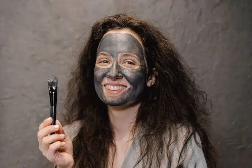 Woman wearing a charcoal facemask