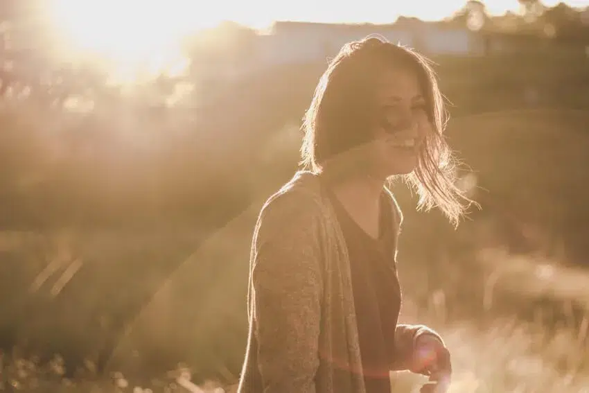 smiling woman illuminated by the sunlight