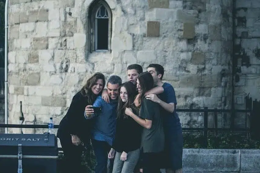 group of friends taking a selfie by a landmark