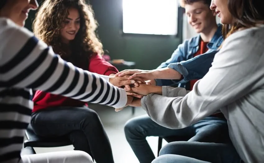group of people holding hands