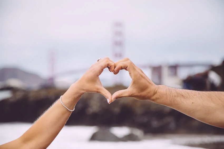 hands from two people forming the shape of a heart
