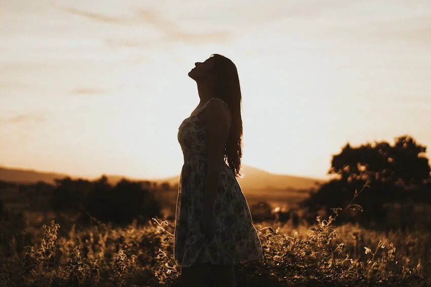 woman with her head raised toward the sky